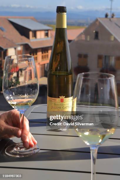 Maison Joseph Cattin Grand Cru Hatschbourg 2017 vintage Riesling wine is served to visitors on the terrace at the winery on October 11, 2019 in the...