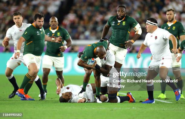 Makazole Mapimpi of South Africa is tackled by Kyle Sinckler and Maro Itoje of England during the Rugby World Cup 2019 Final between England and...