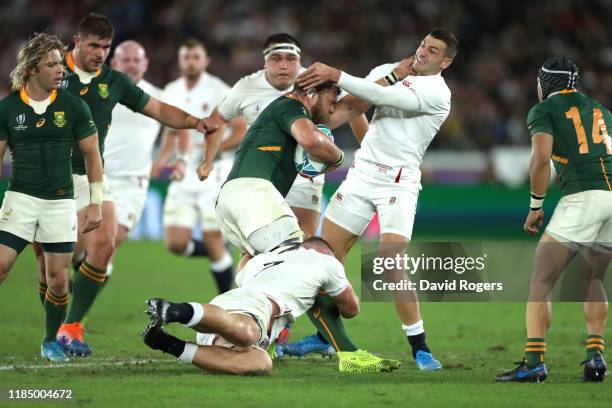 Duane Vermeulen of South Africa is tackled by Jonny May and Sam Underhill of England during the Rugby World Cup 2019 Final between England and South...