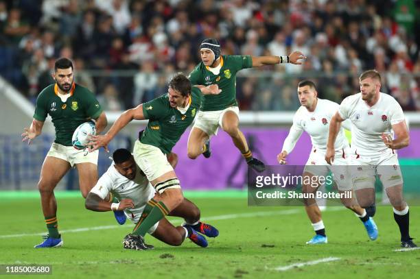 Eben Etzebeth of South Africa offloads the ball to teammate Damian de Allende as he is tackled by Manu Tuilagi of England during the Rugby World Cup...