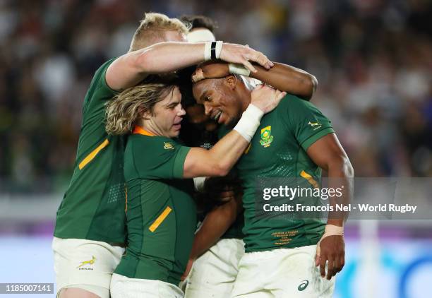 Makazole Mapimpi of South Africa celebrates with Lukhanyo Am, Vincent Koch and Faf de Klerk after scoring his team's first try during the Rugby World...