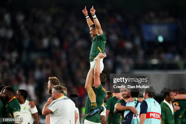 Cheslin Kolbe of South Africa is lifted by Eben Etzebeth of South Africa as they celebrate victory over England following the Rugby World Cup 2019...