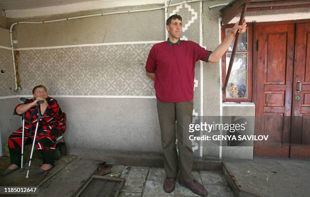 Leonid Stadnyk stands near his mother Galyna at his house in Podoliantsi village, 180 km from Kiev, Saturday, August 11, 2007. Stadnyk, a giant...