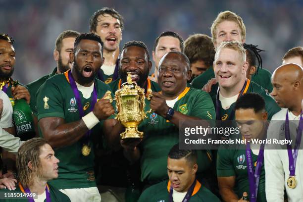 Cyril Ramaphosa, President of South Africa lifts the Web Ellis Cup with Siya Kolisi of South Africa following their victory against England in the...