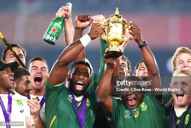 Cyril Ramaphosa, President of South Africa lifts the Web Ellis Cup with Siya Kolisi of South Africa following their victory against England in the...