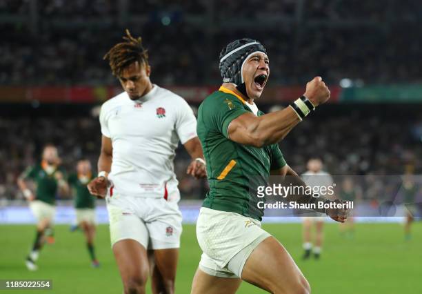 Cheslin Kolbe of South Africa celebrates after scoring the second try as Anthony Watson of England looks dejected during the Rugby World Cup 2019...