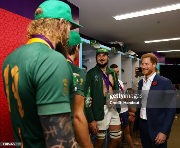 In this handout image provided by World Rugby Prince Harry, Duke of Sussex speaks to players of South Africa following their victory against England...