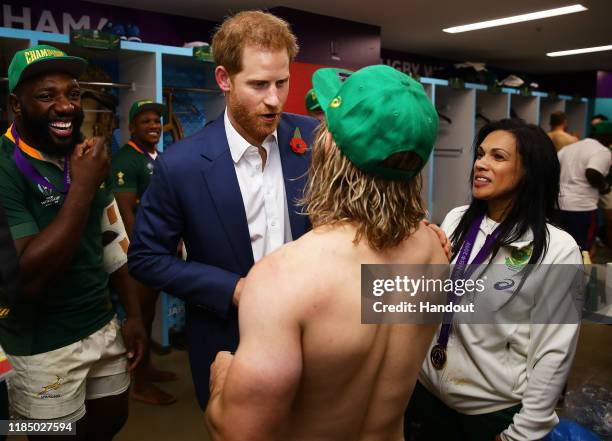 In this handout image provided by World Rugby Prince Harry, Duke of Sussex congratulates Faf de Klerk of South Africa following his team's victory...