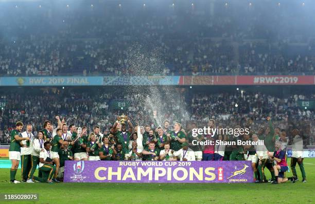 Players of South Africa spray beer as Siya Kolisi of South Africa lifts the Web Ellis cup following their victory against England in the Rugby World...