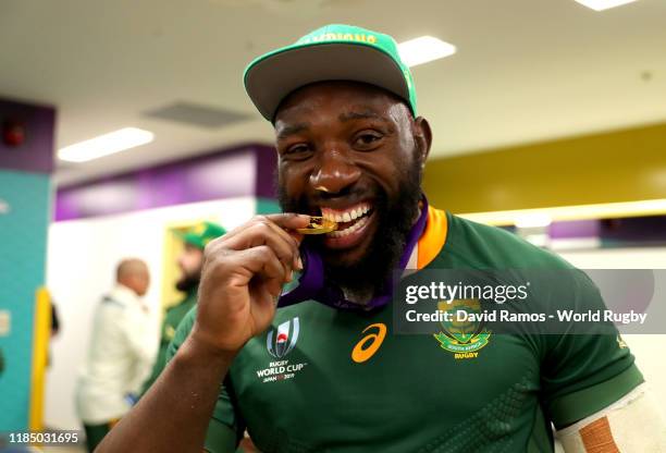 Tendai Mtawarira of South Africa pose for a photo with his gold medal in the South Africa changing room following his team's victory against England...