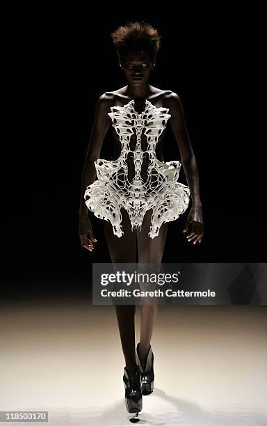 Model walks the catwalk at the Iris van Herpen Show during Mercedes-Benz Fashion Week Berlin Spring/Summer 2012 at the Brandenburg Gate on July 8,...