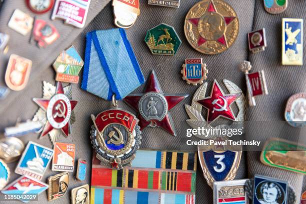 soviet-era medals and jacket pins - soviet communist society stock pictures, royalty-free photos & images