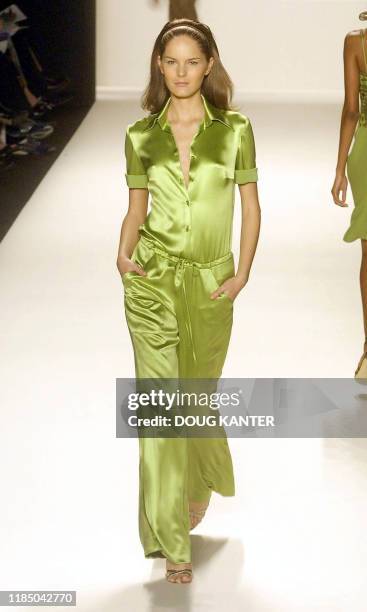 Model wears a peridot crepe back satin shirt and drawstring pant at the Carolina Herrera Spring 2003 fashion show in New York 18 September 2002. AFP...