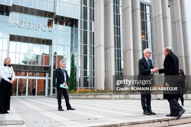 Interpol Secretary-General Jurgen Stock welcomes Mayor of Lyon and former France's Interior Minister Gerard Collomb , upon his arrival at the...