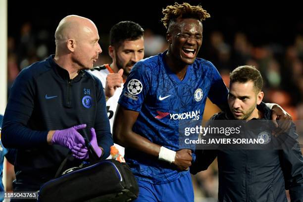 Chelsea's English striker Tammy Abraham is helped after resulting injured during the UEFA Champions League Group H football match between Valencia CF...