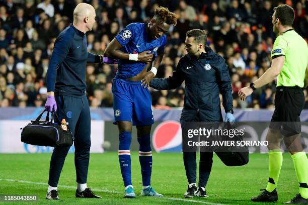 Chelsea's English striker Tammy Abraham is helped after resulting injured during the UEFA Champions League Group H football match between Valencia CF...