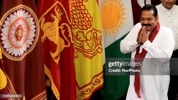 Sri Lanka's prime minister Mahinda Rajapaksa greets as he arrives at a ministerial swearing-in ceremony at the Presidential Secretariat in Colombo,...