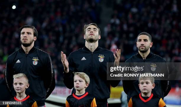 Benfica's Portuguese defender Ferro prays next to Benfica's Portuguese defender Ruben Dias and Benfica's Portuguese defender Adil Taarabt prior to...