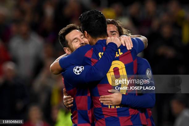 Barcelona's Argentine forward Lionel Messi is congratulated by teammates Barcelona's French forward Antoine Griezmann and Barcelona's Uruguayan...