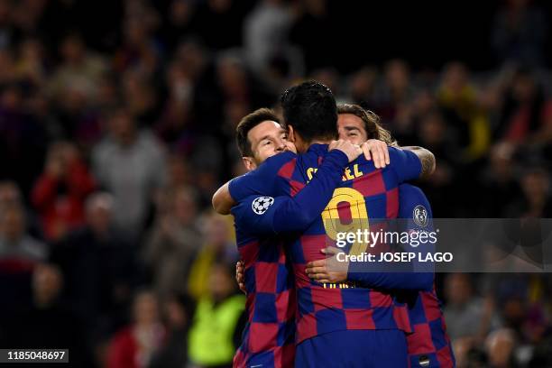 Barcelona's Argentine forward Lionel Messi is congratulated by teammates Barcelona's French forward Antoine Griezmann and Barcelona's Uruguayan...