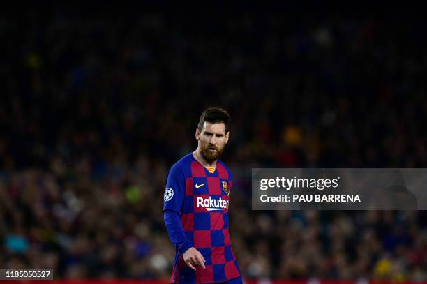 Barcelona's Argentine forward Lionel Messi walkson the pitch during the UEFA Champions League Group F football match between FC Barcelona and...