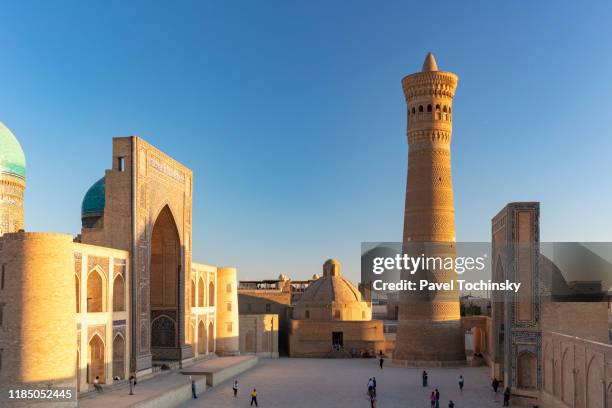 16th century miri-arab madrasah and kalyan minaret built by the qarakhanid ruler mohammad arslan khan in 1127, bukhara, uzbekistan - gateway high school stock pictures, royalty-free photos & images