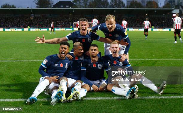 Elias Kachunga, Juninho Bacuna, Jonathan Hogg, Lewis O'Brien and Florent Haderjonaj join Karlan Grant of Huddersfield Town to celebrate his opening...