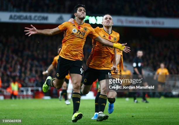 Raul Jimenez of Wolverhampton Wanderers celebrates with teammates Diogo Jota and Ruben Vinagre after scoring his team's first goal during the Premier...