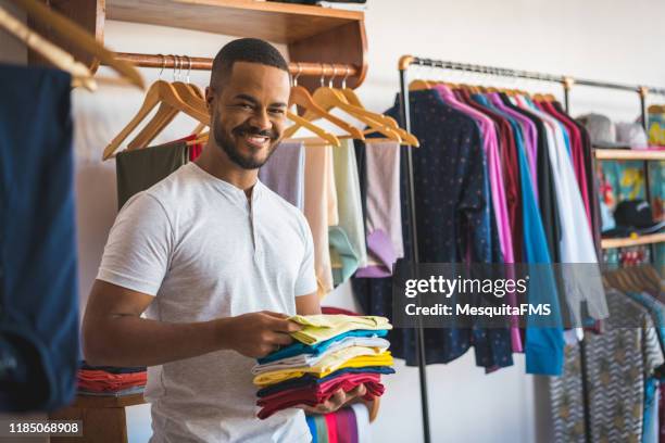 portrait of afro man in the clothing store - salesman imagens e fotografias de stock
