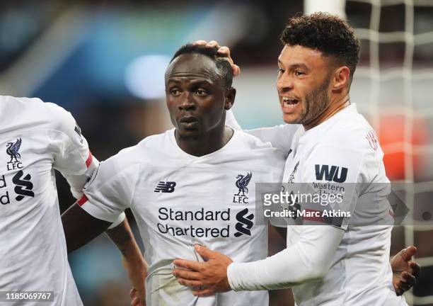 Sadio Mane of Liverpool celebrates with teammate Alex Oxlade-Chamberlain after scoring his team's second goal during the Premier League match between...