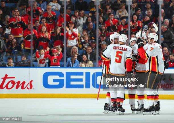 Brodie of the Calgary Flames celebrates his first period goal with teammates during an NHL game against the Buffalo Sabres on November 27, 2019 at...