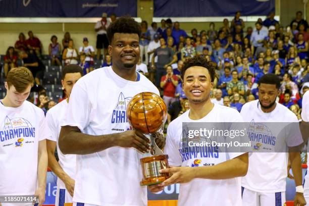 Co-MVPs Udoka Azubuike and Devon Dotson of the Kansas Jayhawks pose for a photo with the MVP trophy after winning the championship game of the 2019...