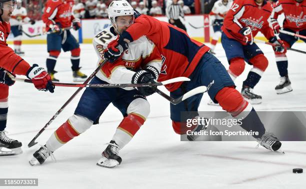 Panthers center Denis Malgin is impeded by Capitals defenseman Radko Gudas during the Florida Panthers vs. Washington Capitals on November 27, 2019...