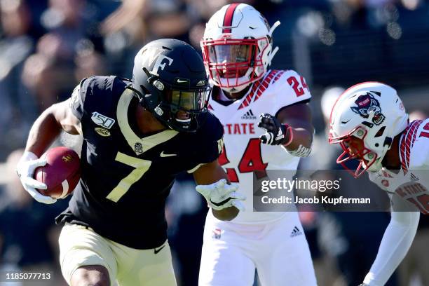 Scotty Washington of the Wake Forest Demon Deacons runs with the ball in the first quarter during their game against the North Carolina State...