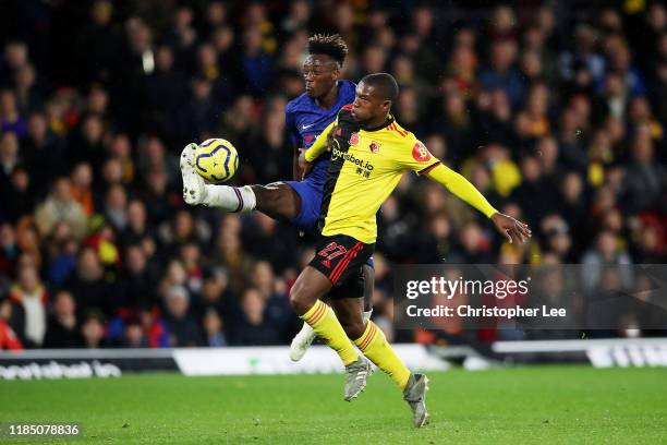 Tammy Abraham of Chelsea controls the ball as he is challenged by Christian Kabasele of Watford during the Premier League match between Watford FC...