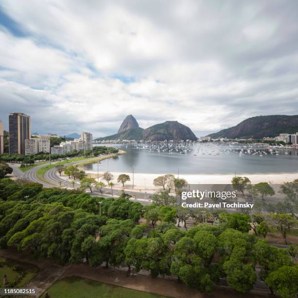 botafogo bay overlooking sugarload mountain on an overcast day, rio de janeiro, brazil - botafogo brazil stock pictures, royalty-free photos & images