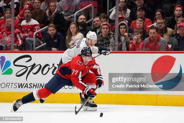 Oshie of the Washington Capitals and Jonathan Huberdeau of the Florida Panthers battle for the puck in the third period at Capital One Arena on...