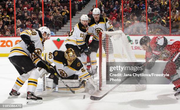 Tuukka Rask of the Boston Bruins makes a save against Connor Brown of the Ottawa Senators as Matt Grzelcyk, Charlie Coyle and Brandon Carlo of the...