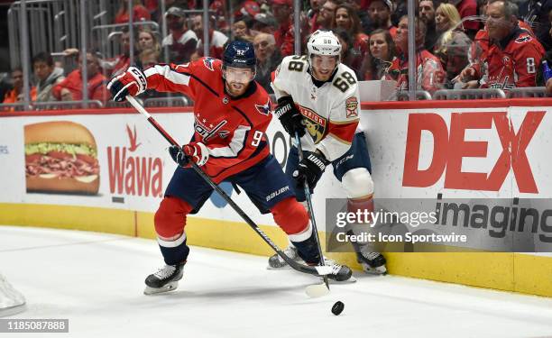 Capitals center Evgeny Kuznetsov beats Panthers center Mike Hoffman to a puck during the Florida Panthers vs. Washington Capitals on November 27,...