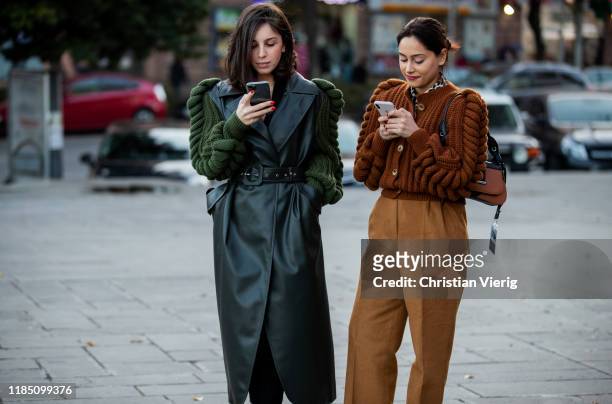 Guest is wearing brown knit and a guest wearing green leather coat with knitted sleeves seen during day 3 of the Mercedes-Benz Tbilisi Fashion Week...