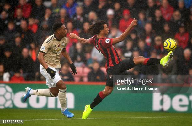 Nathan Ake of AFC Bournemouth looks to control the ball under pressure from Anthony Martial of Manchester United during the Premier League match...