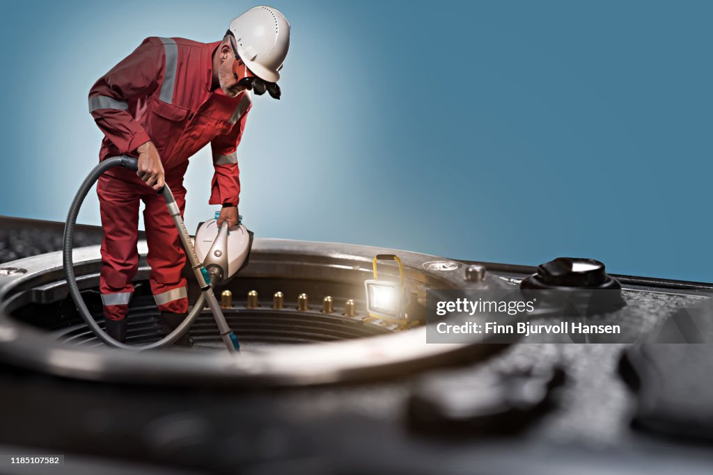 Technician standing on camera cleaning camera sensor