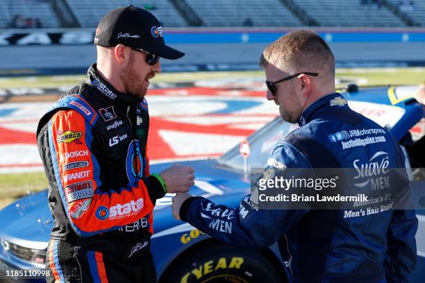 Justin Allgaier, driver of the Suave Men Chevrolet, speaks with Jeb Burton, driver of the State Water Heaters Chevrolet, on the grid during the...