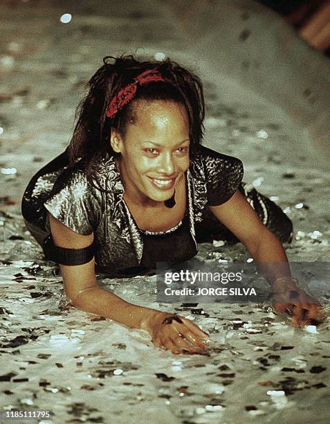 Model is in the footbridge playing with water during the presentation of the Spring-Fall 2000 line by Grypho on the night of 29 March, 2000 during...