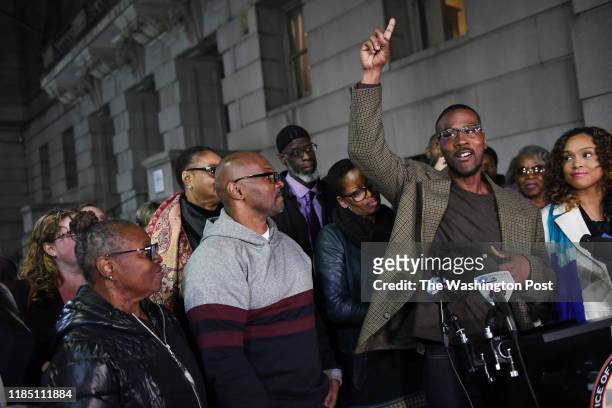 Alfred Chestnut, right, speaks after he, Andrew Stewart, left center, and Ransom Watkins, back center, were released and exonerated for the 1983...