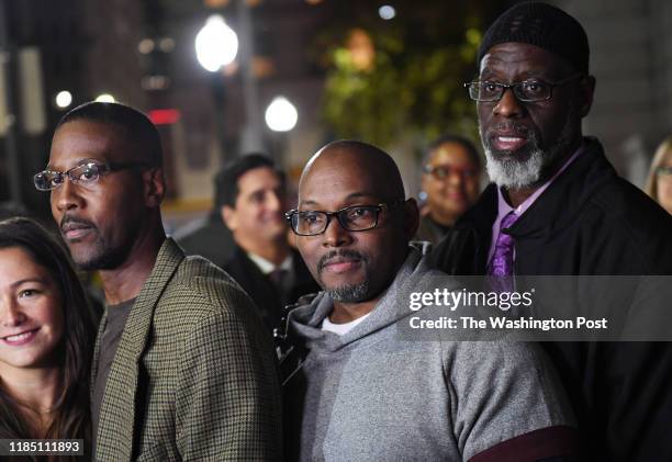 Alfred Chestnut, left to right, Andrew Stewart, and Ransom Watkins pose for a photographer after they were released and exonerated for the 1983...