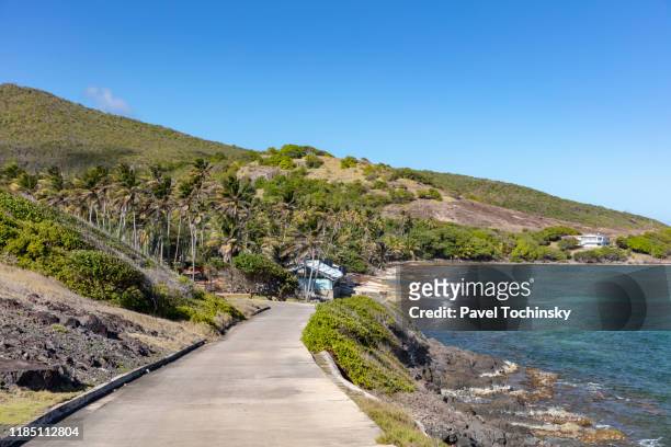 road on the windward side of bequia, spring bay, saint vincent and the grenadines, 2019 - bequia stock pictures, royalty-free photos & images