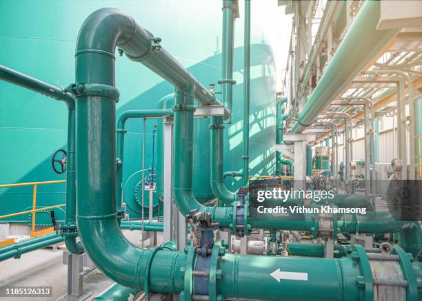 valves and pipeline system of industrial zone, steel pipeline and valves at factory - パイプライン ストックフォトと画像