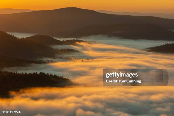 morning fog at sunrise fills a valley in vermont's green mountains - green mountain range stock pictures, royalty-free photos & images