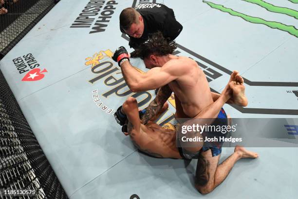 Shane Burgos punches Makwan Amirkhani of Finland in their featherweight bout during the UFC 244 event at Madison Square Garden on November 02, 2019...